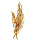 “Palm branch” brooch in 18K yellow gold, with chiseled and textured gold.